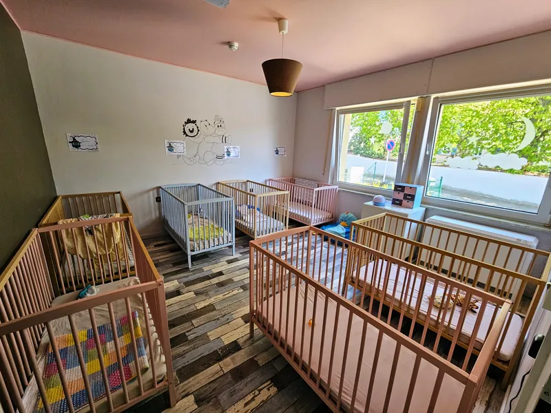 A sleeping room with small beds
