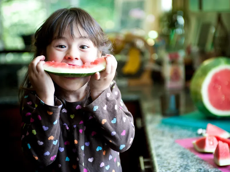 A little girl eating watermelon